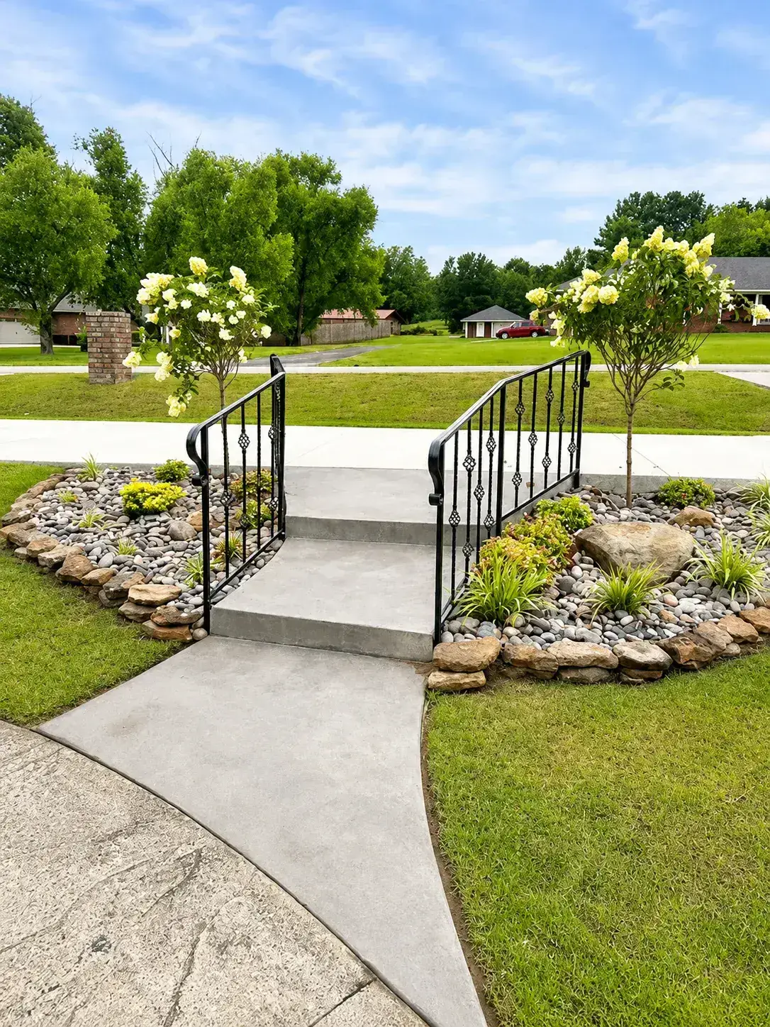 Decorative iron step railings on concrete walkway — ACE Fence Company